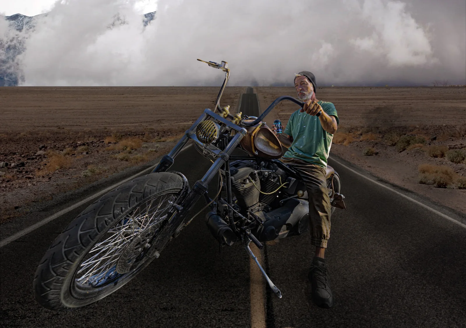 Creative composite featuring a motorcycle rider on an open desert road